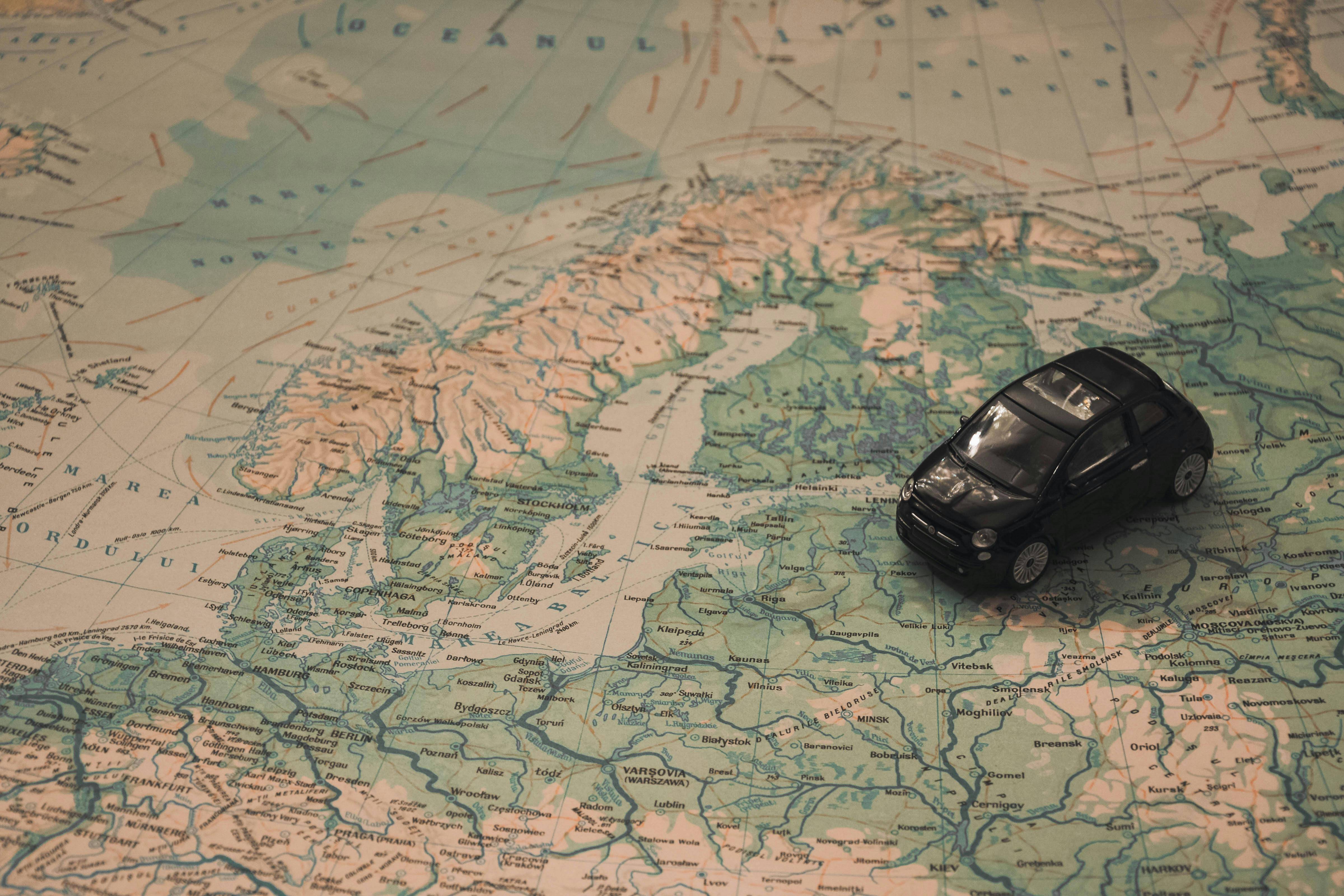 toy car driving over map of europe